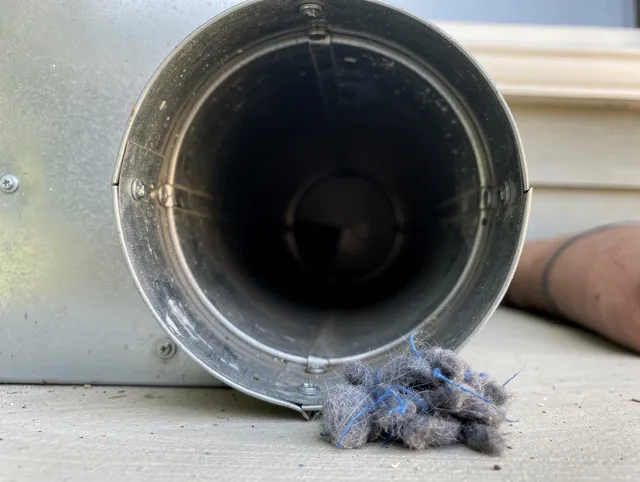 Stoneham Dryer Vent Cleaning technician using specialized equipment to clear severe dryer vent blockage in Stoneham